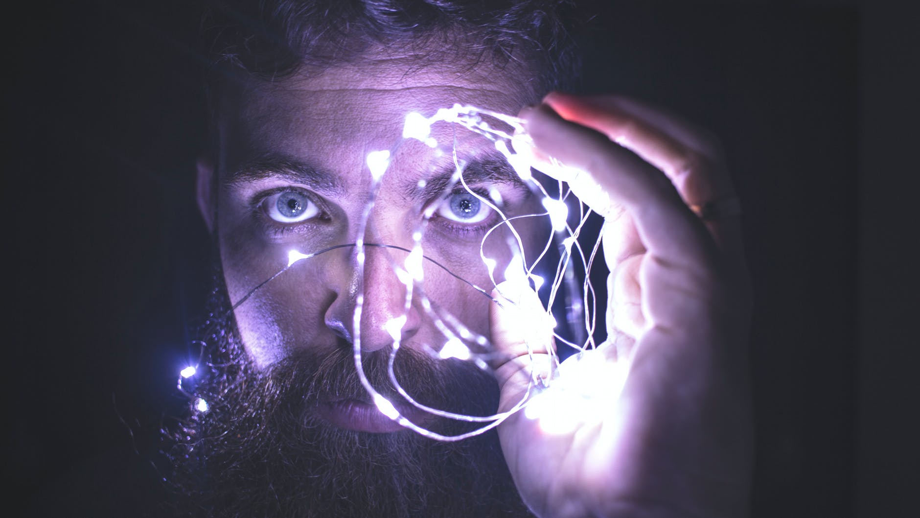 Image of a person holding string lights representing vision for team performance.