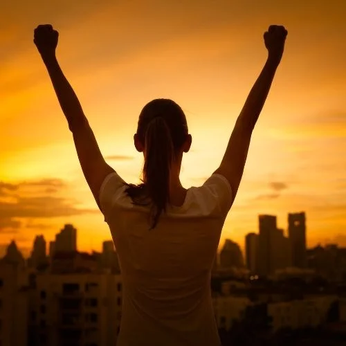 Image of woman celebrating success.