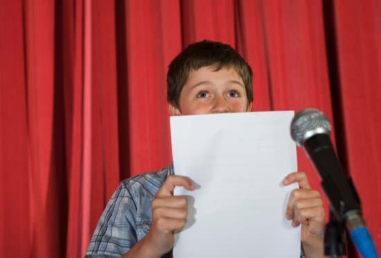 Image of a boy reading from a script.