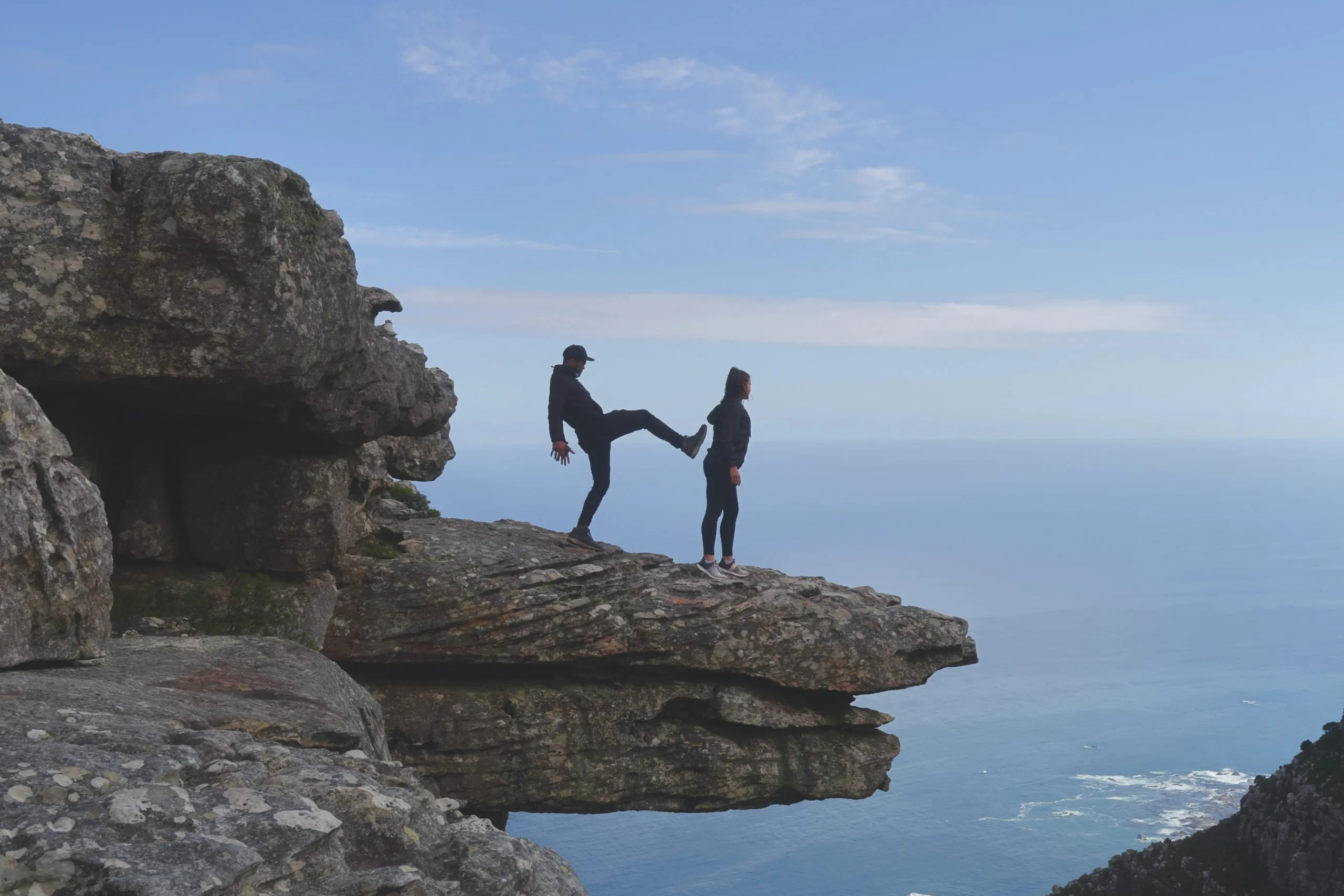 Image of person about to be pushed off cliff representing a boss, leader, supervisor, manger being too pushy.