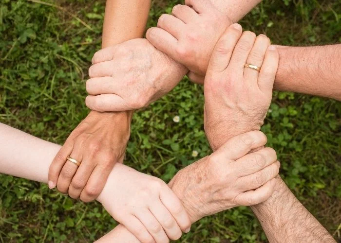 Interlocked arms for building trust in the workplace.