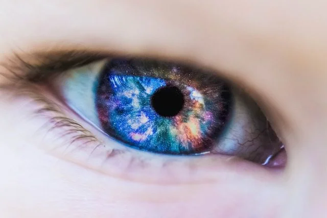 Close up of a eyeball with colors of the universe inside