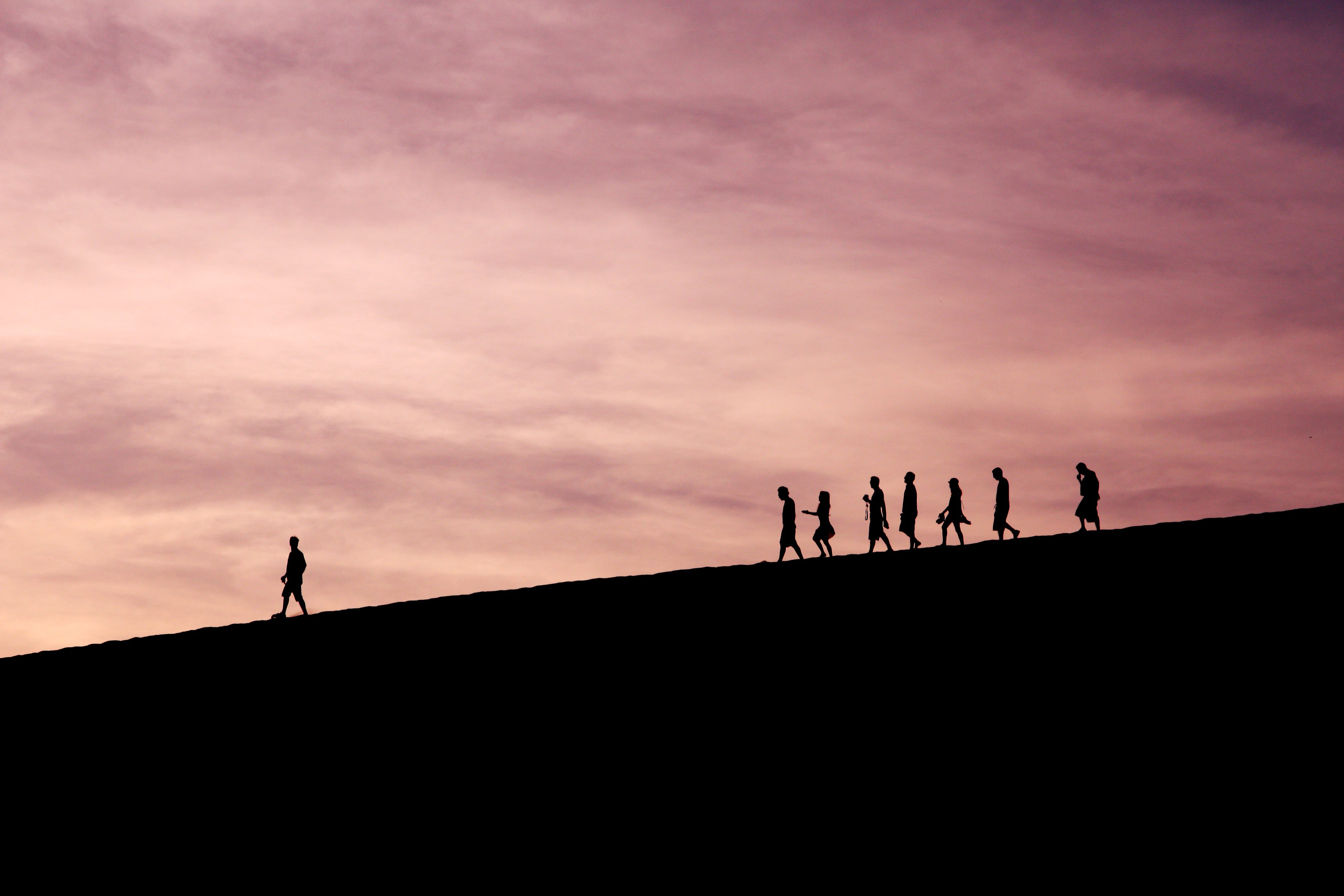 Person walking with others following.