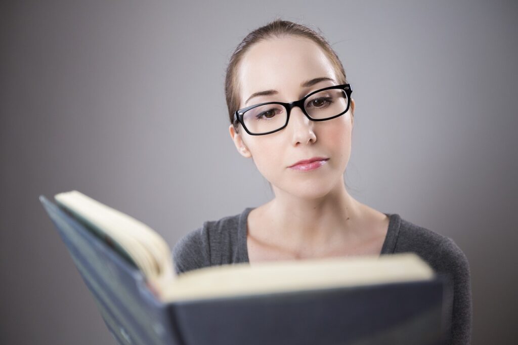 Woman reading a book to help her get out of her dead-end job and get a better career.