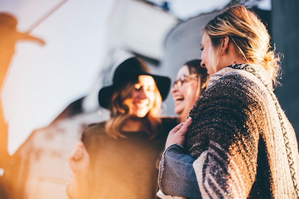 Women talking using different types of interpersonal communication skills.