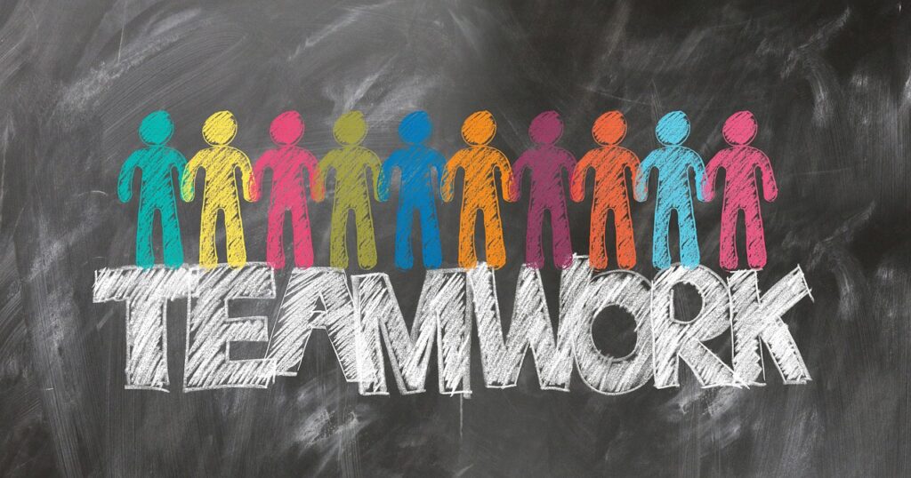 colorful figures standing over the word teamwork